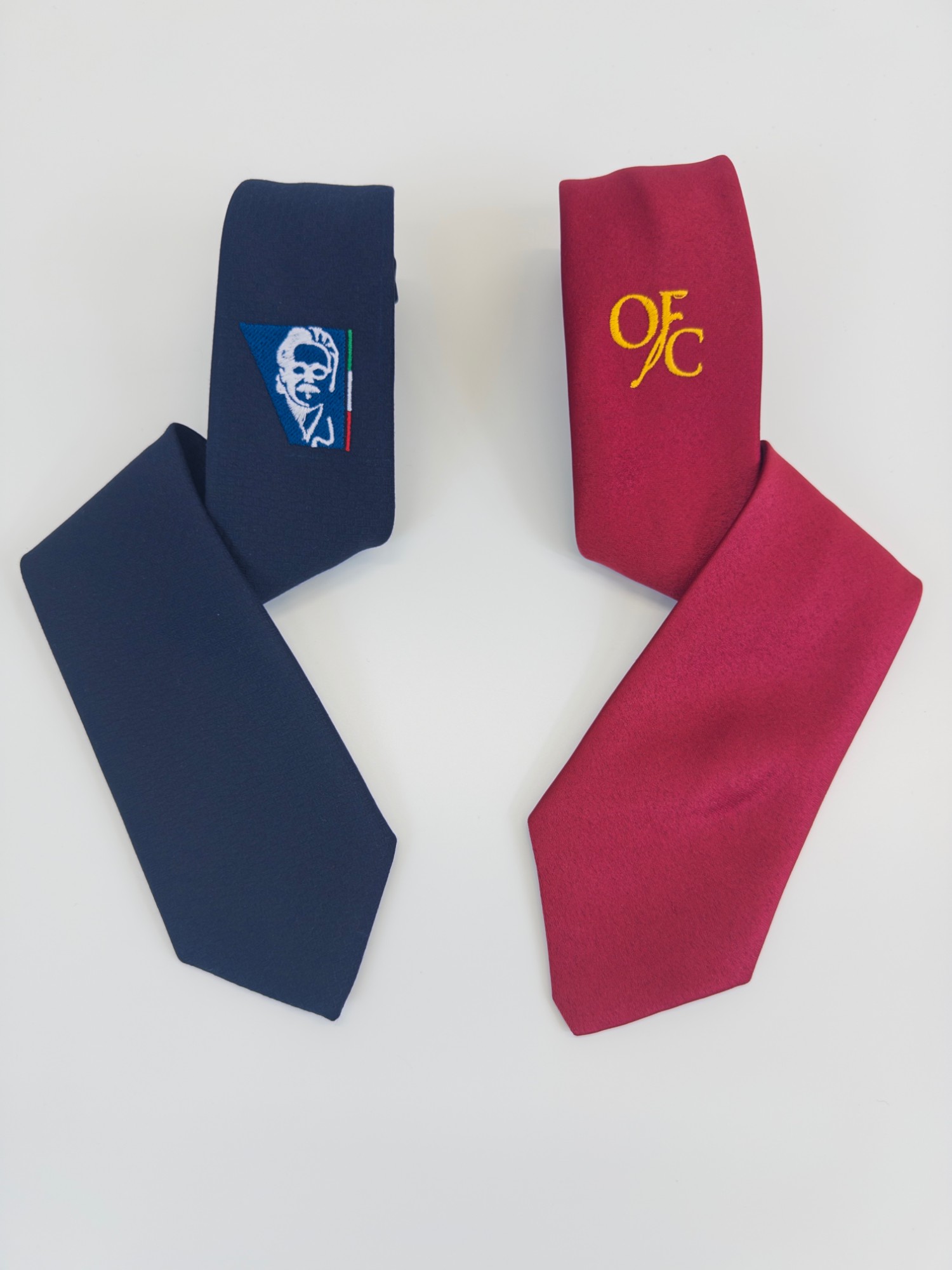 Two embroidered ties: blue with the portrait and the tricolour, burgundy with the gold OFC monogram
